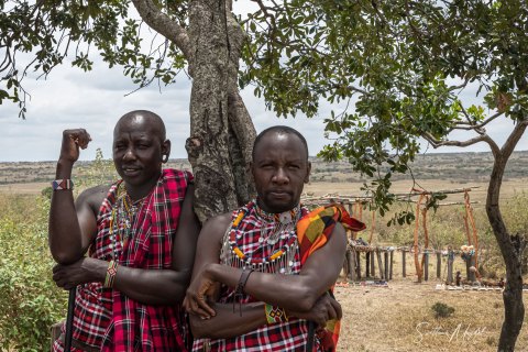 SVM_7887 
Maasai Men in traditional  colourful   warrior outfit; red shuka cloth beaded necklaces, an iron rod (as a weapon)